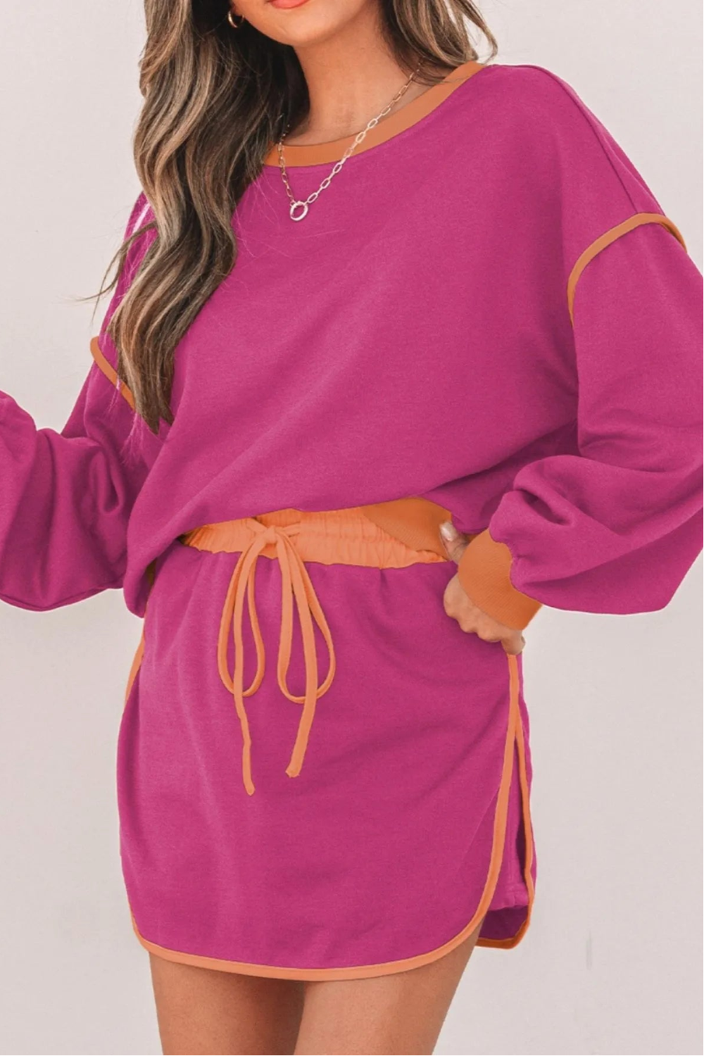 Two-piece skort set, pullover, oversized, long sleeve, drop shoulder, contrast trim, elastic waist, drawstring closure, slightly stretchy front view