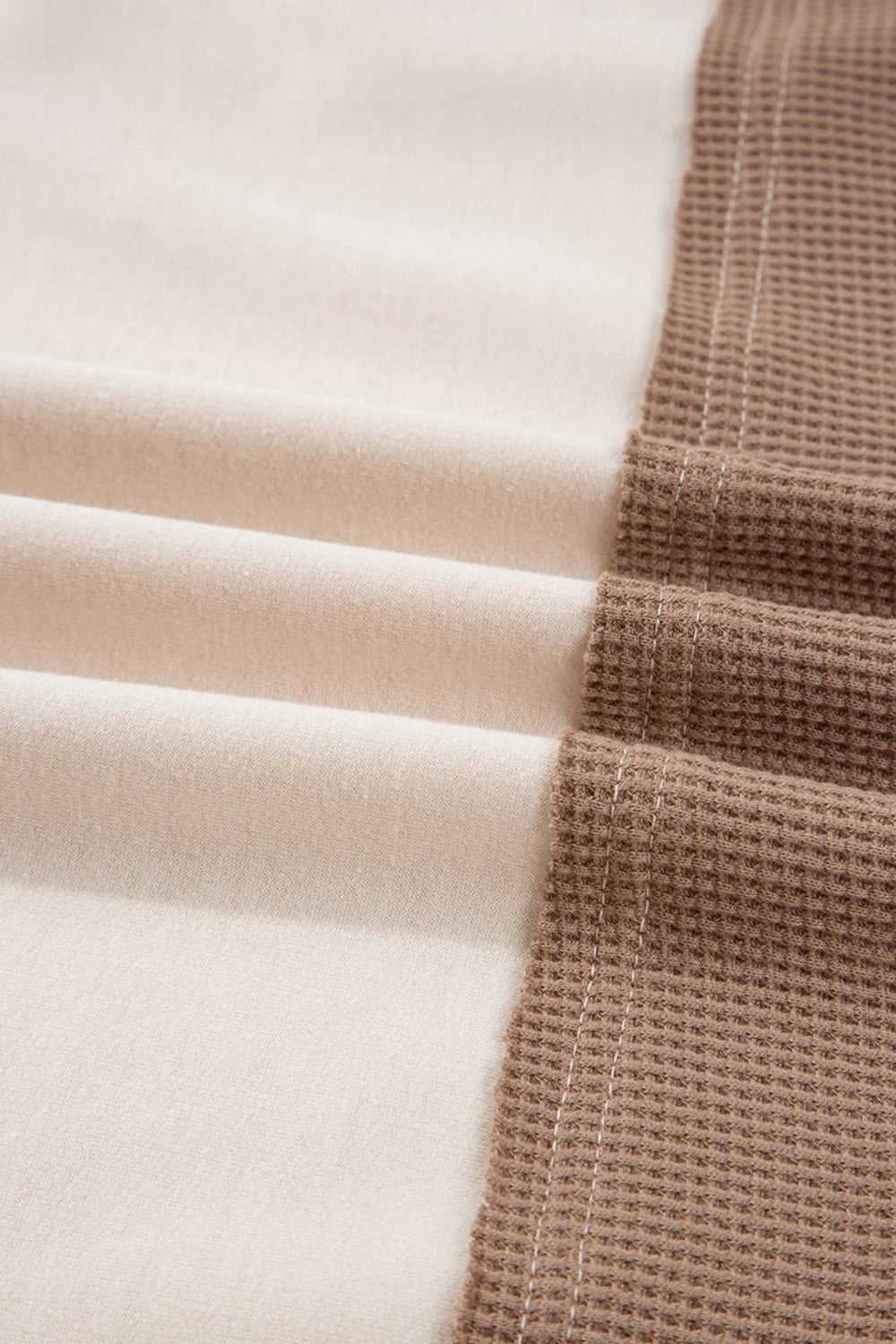 Top, henley, pullover, long sleeve, round neck, color block, waffle-knit, buttoned, slightly stretchy, close up view