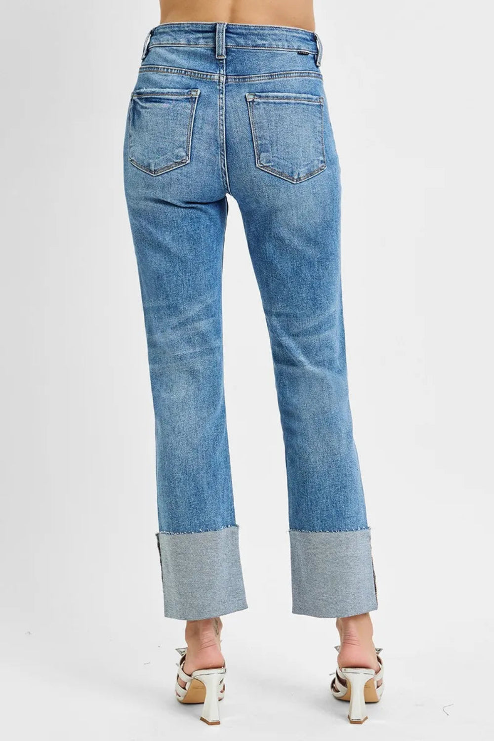 Risen jeans, full-size high-rise, wide cuffed, ankle length, straight leg, raw hem, distressed, vintage medium wash  5-pocket detail, button-zipper closure, belt looped, straight leg, ankle length, slightly stretchy, back view