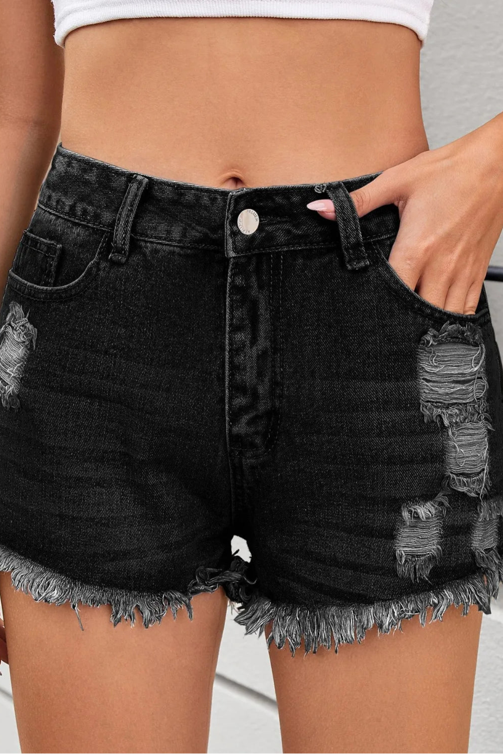 Distressed, Raw hem, High waist, Zipper and button closure, Functioning pockets,  No stretch, Denim shorts Close up view