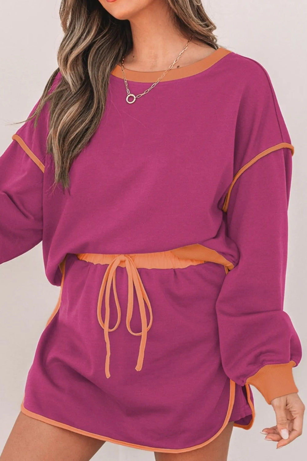 Two-piece skort set, pullover, oversized, long sleeve, drop shoulder, contrast trim, elastic waist, drawstring closure, slightly stretchy front view