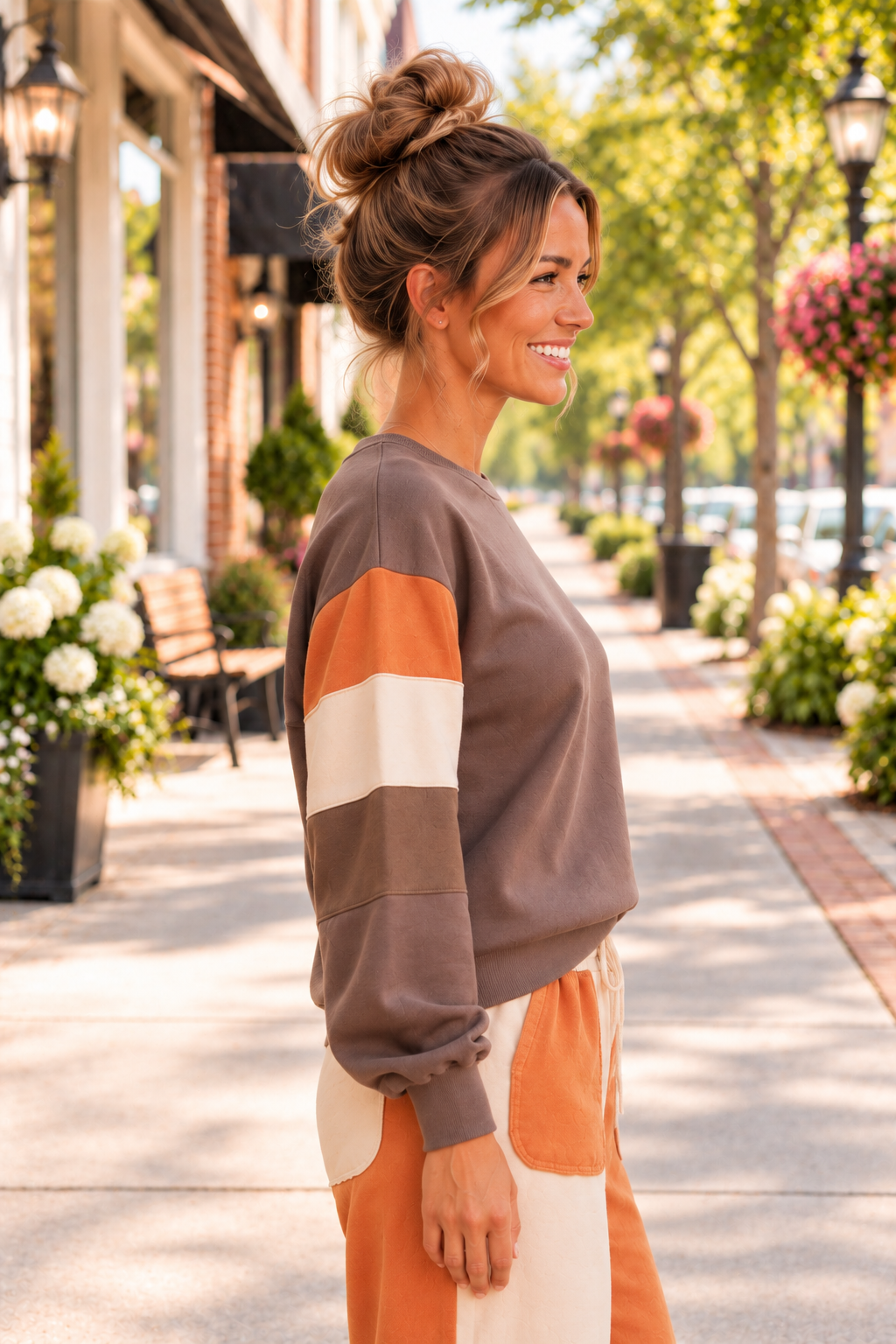 A Change Of Pace Sweatshirt in mocha brown with rust-orange and cream color-block sleeves, shown from the side.