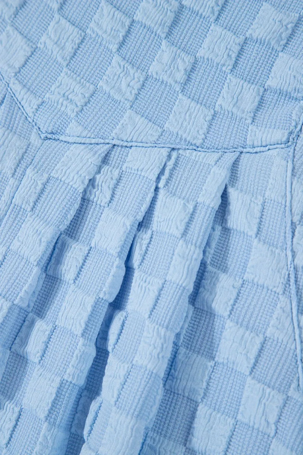 Overalls, square neck, wide leg, checkered, pocketed, buttoned straps, high waist, pleated, some stretch, close up view