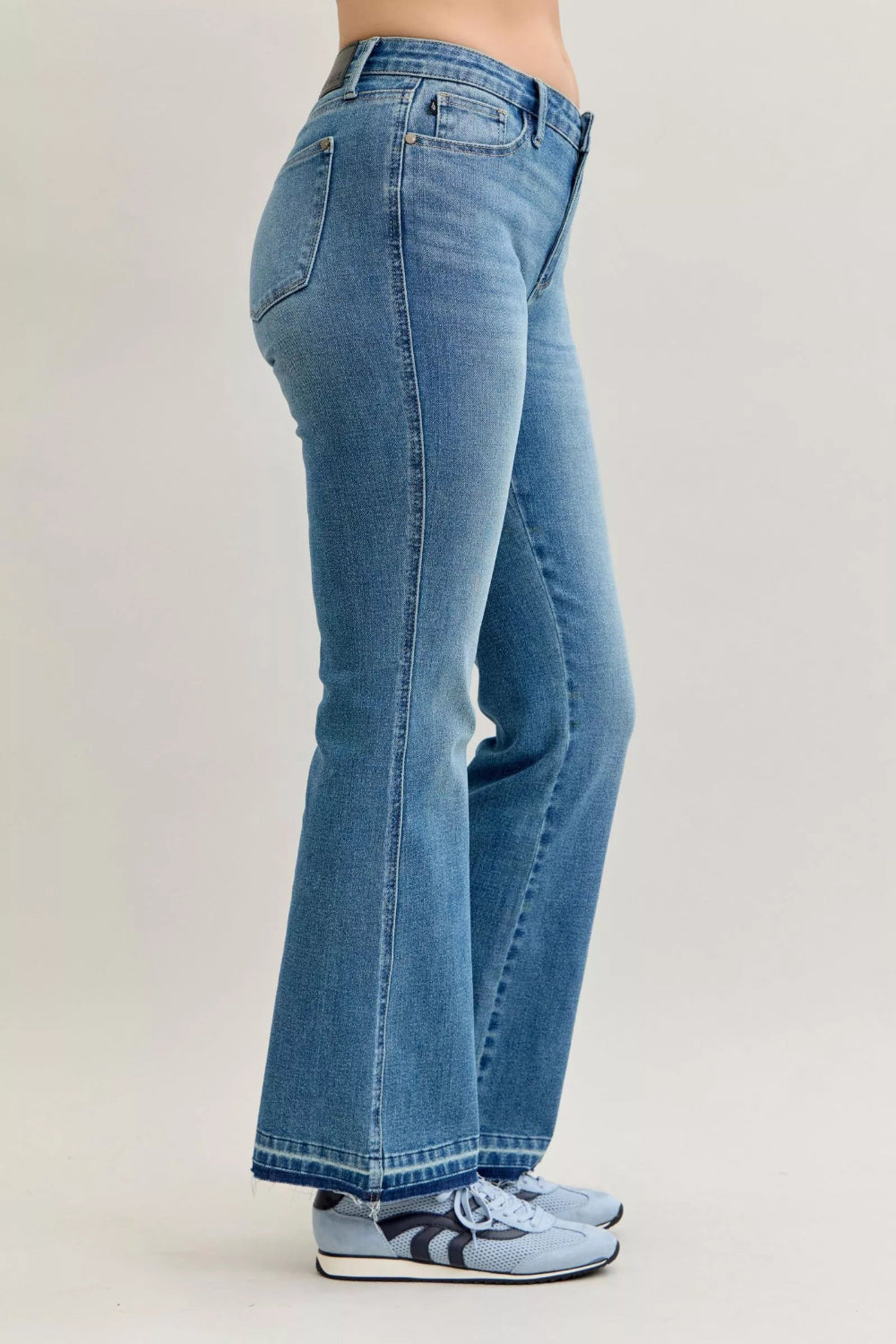 Judy Blue Jeans, full-size, mid-rise, medium wash, slim, bootcut, tummy control, release hem, pocketed, belt loops, button/zipper closure, raw hem, slightly stretchy, side view