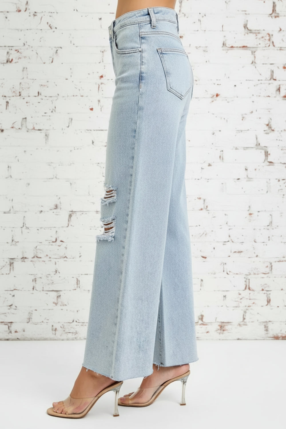Risen Jeans, full-size, high-rise, wide leg, palazzo style, light wash, raw hem, button/zipper closure, belt loops, pocketed, slightly stretchy, side view
