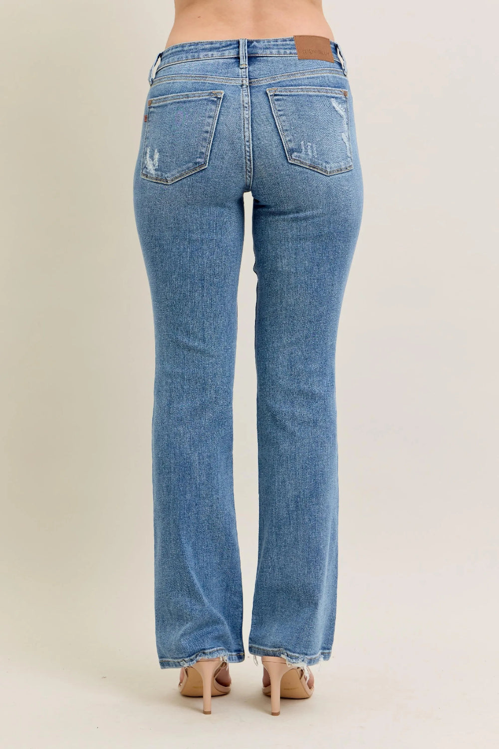 Judy Blue Jeans, mid-rise, full-size, washed, pocketed, raw hem, bootcut, slightly stretchy back view
