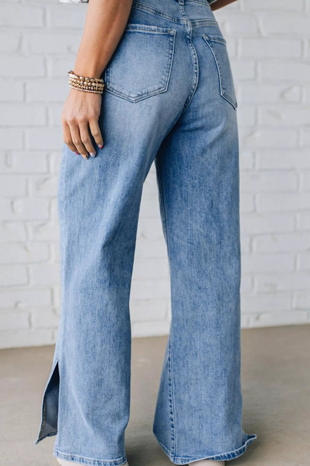 Jeans, slide slit, loose fit, wide leg, vintage wash, drawstring, button/zipper closure, pocketed, belt loops, some stretch, back view
