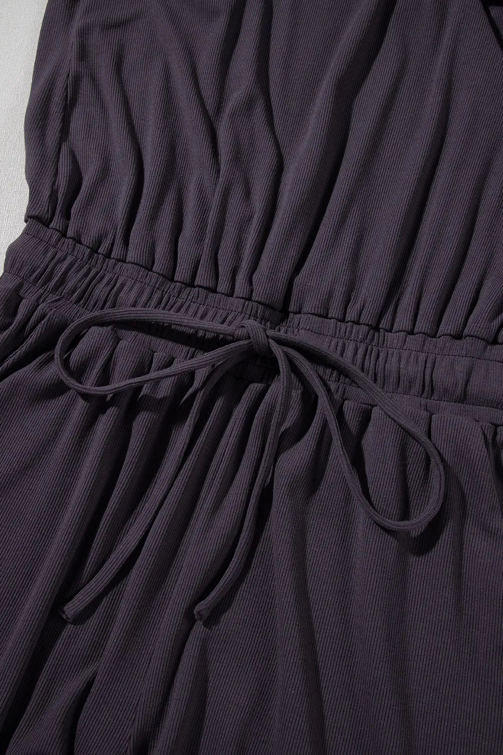 romper, round neck, cap sleeve, knit , drawstring waist, elastic waist, drawstring, button top open back, pleated, stretchy close up view