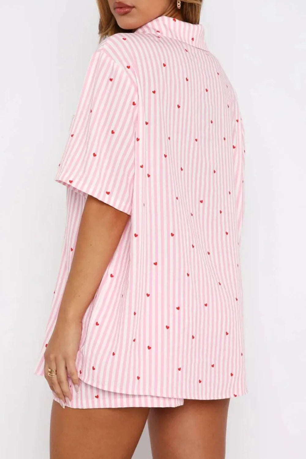 two-piece pajama set, striped with hearts, collared neck, short sleeve, front pocket, button down, shorts, elastic waist, bow tie, some stretch, back view