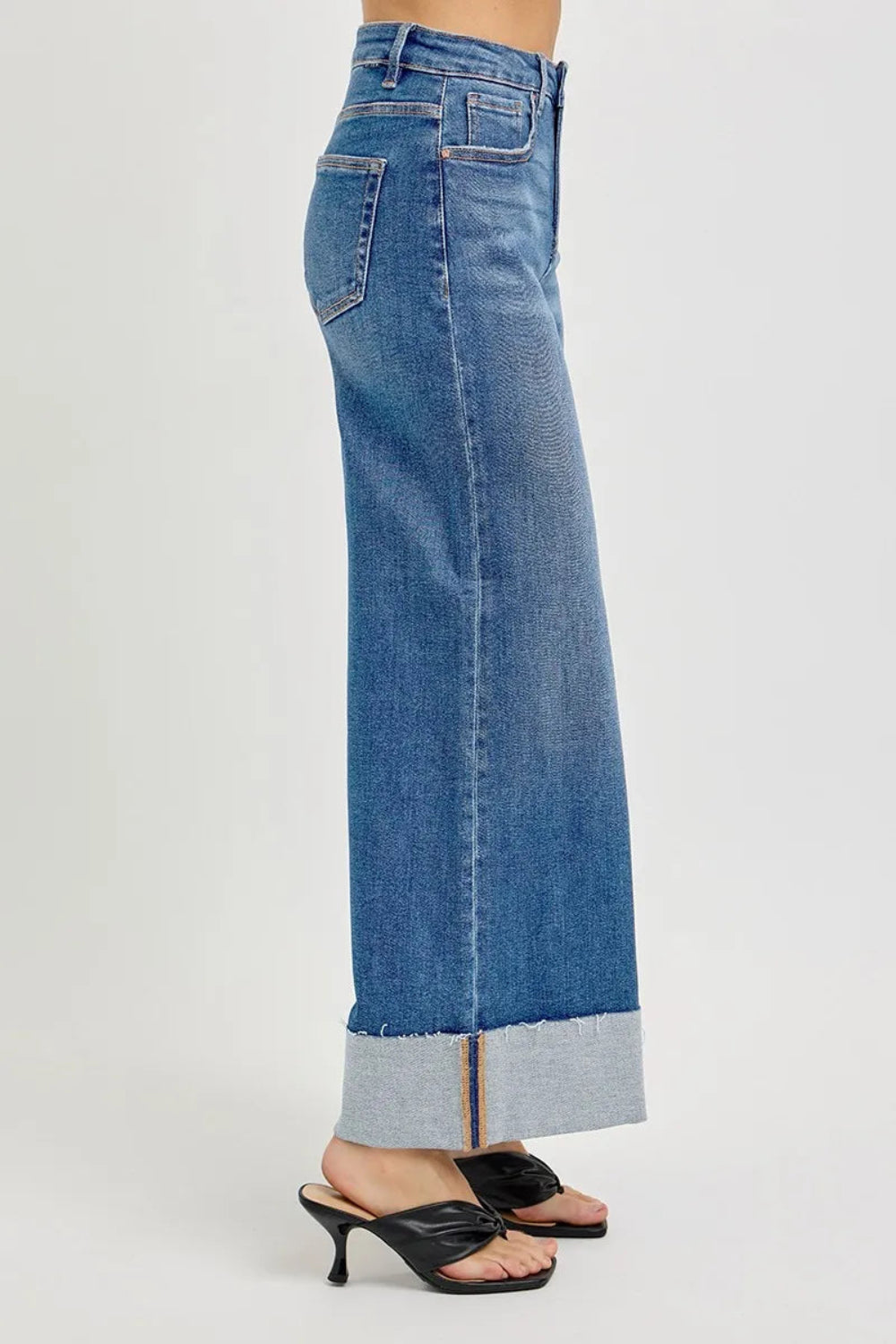 Risen blue jeans, full-size high-rise, tummy control, cropped, wide leg, cuffed, 5-pocket detail, button-zipper closure, belt looped, raw hem, medium wash, slightly stretchy, side view