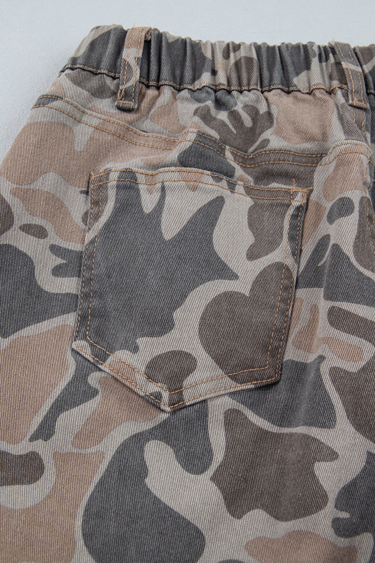 Back close up view of the Incognito Jeans in muted taupe and gray camouflage with wide cropped legs and oversized patch pockets.