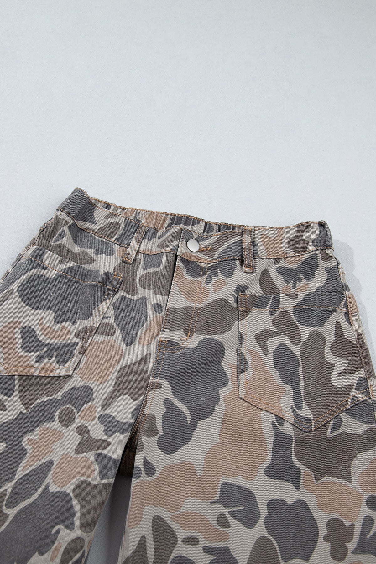 Front close up view of the Incognito Jeans in muted taupe and gray camouflage with wide cropped legs and oversized patch pockets.