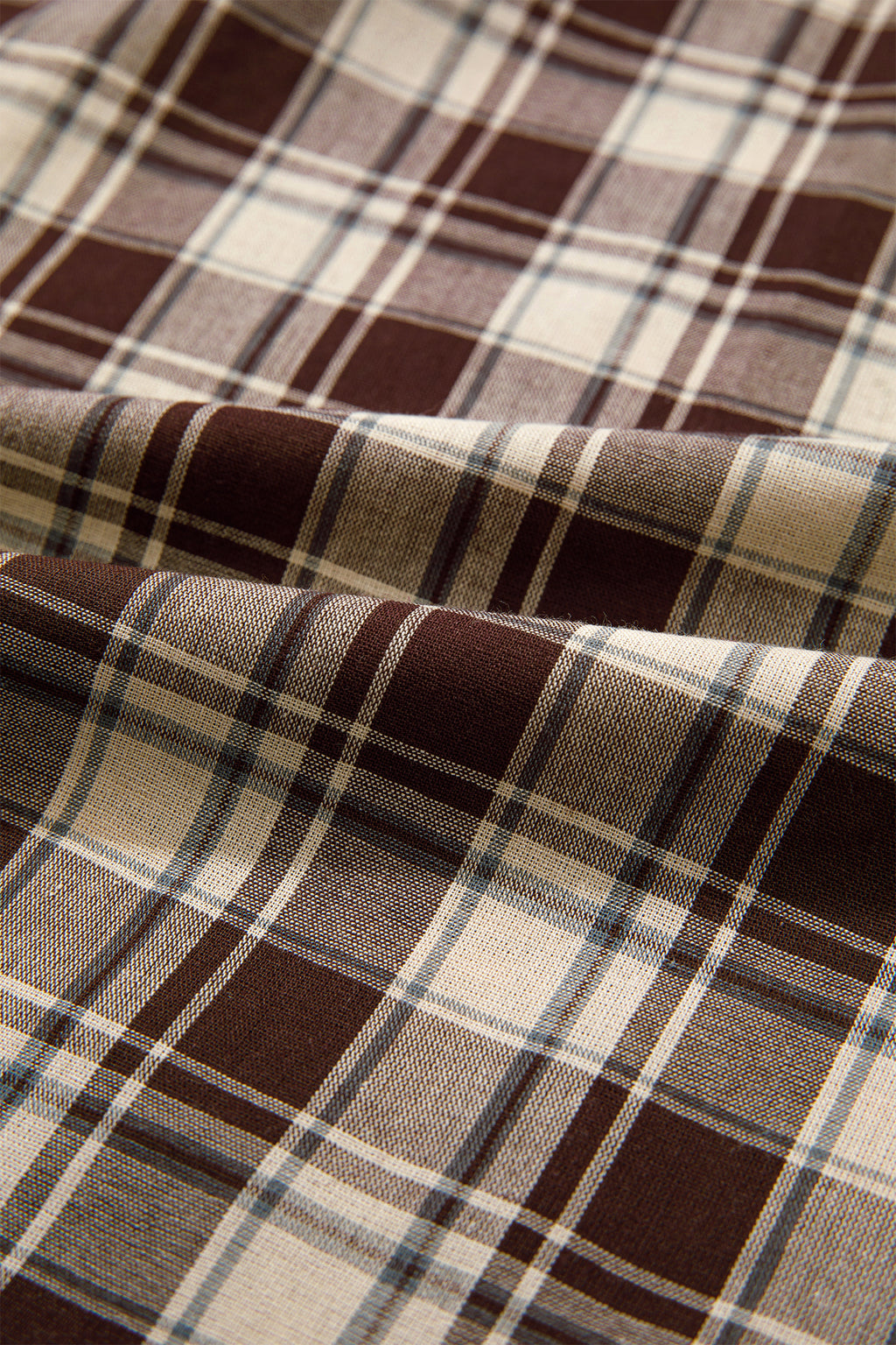 Front view of the Well Thought Of Mini Dress in brown and cream plaid with a collared button front, long sleeves, and pockets.