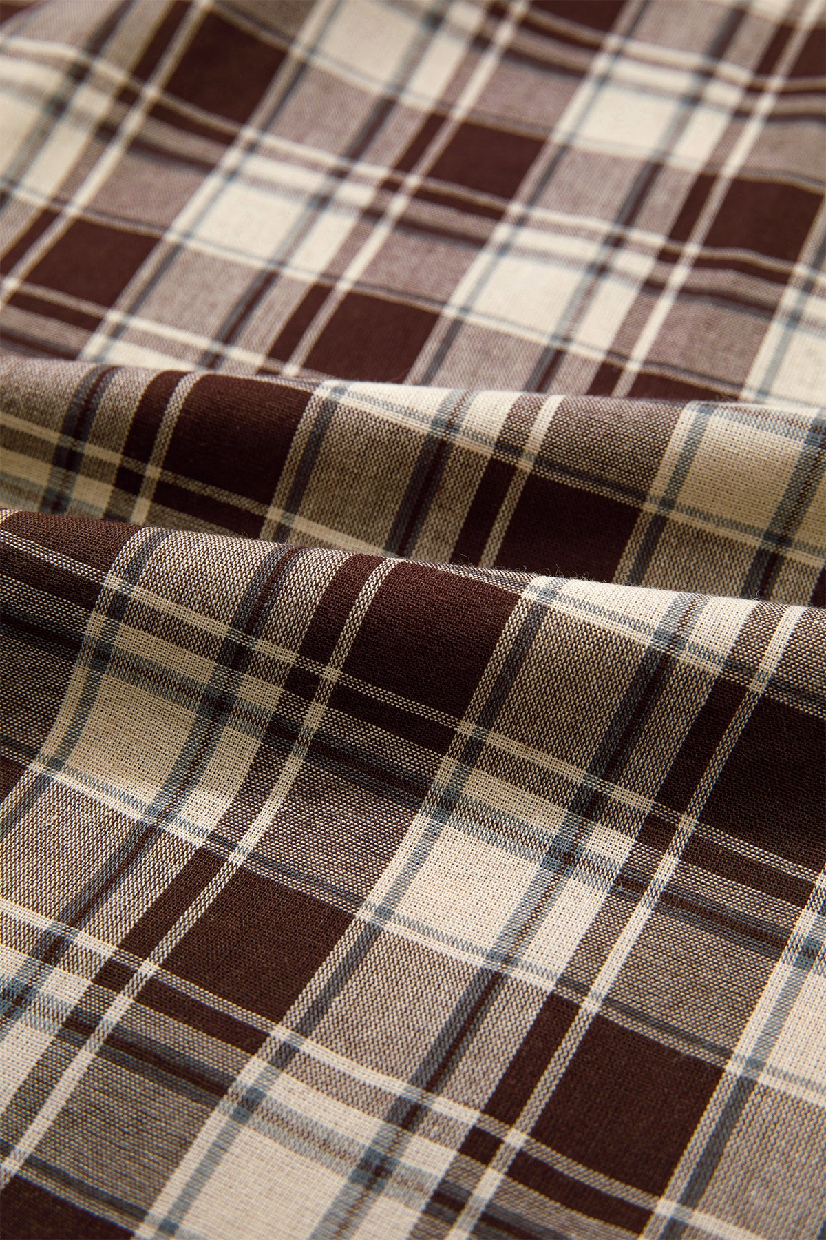 Front view of the Well Thought Of Mini Dress in brown and cream plaid with a collared button front, long sleeves, and pockets.