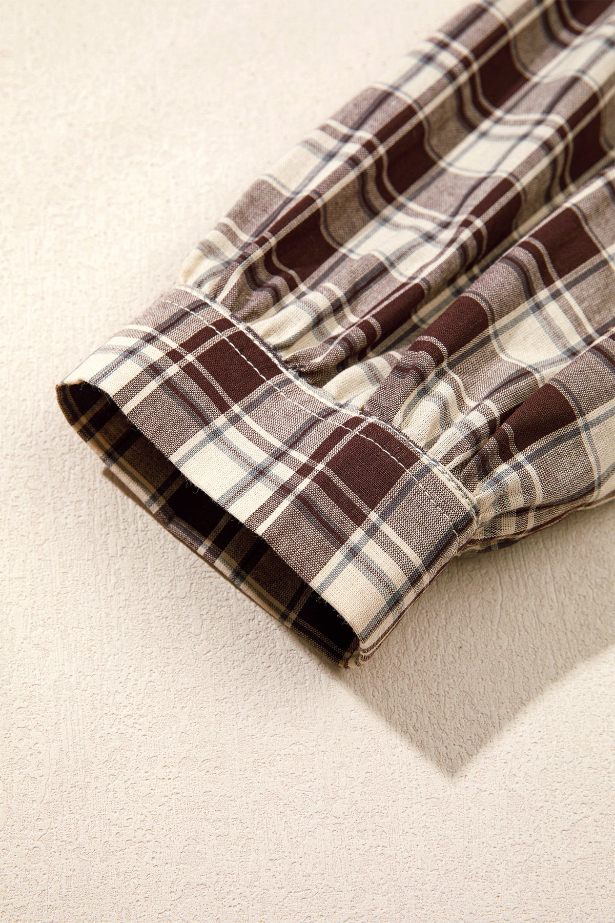 Front view of the Well Thought Of Mini Dress in brown and cream plaid with a collared button front, long sleeves, and pockets.