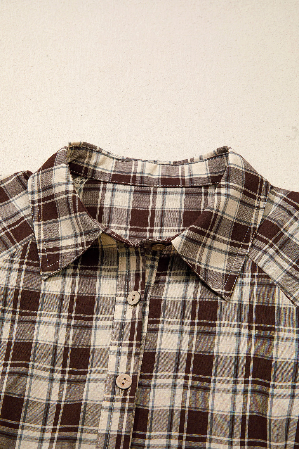 Front view of the Well Thought Of Mini Dress in brown and cream plaid with a collared button front, long sleeves, and pockets.