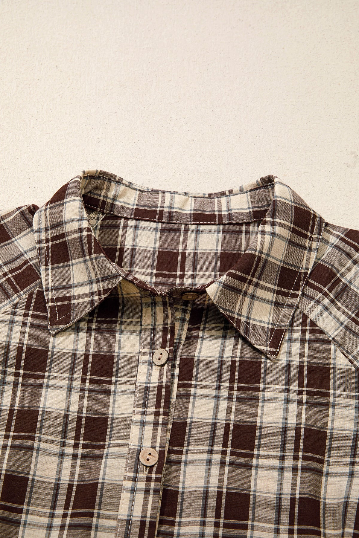 Front view of the Well Thought Of Mini Dress in brown and cream plaid with a collared button front, long sleeves, and pockets.