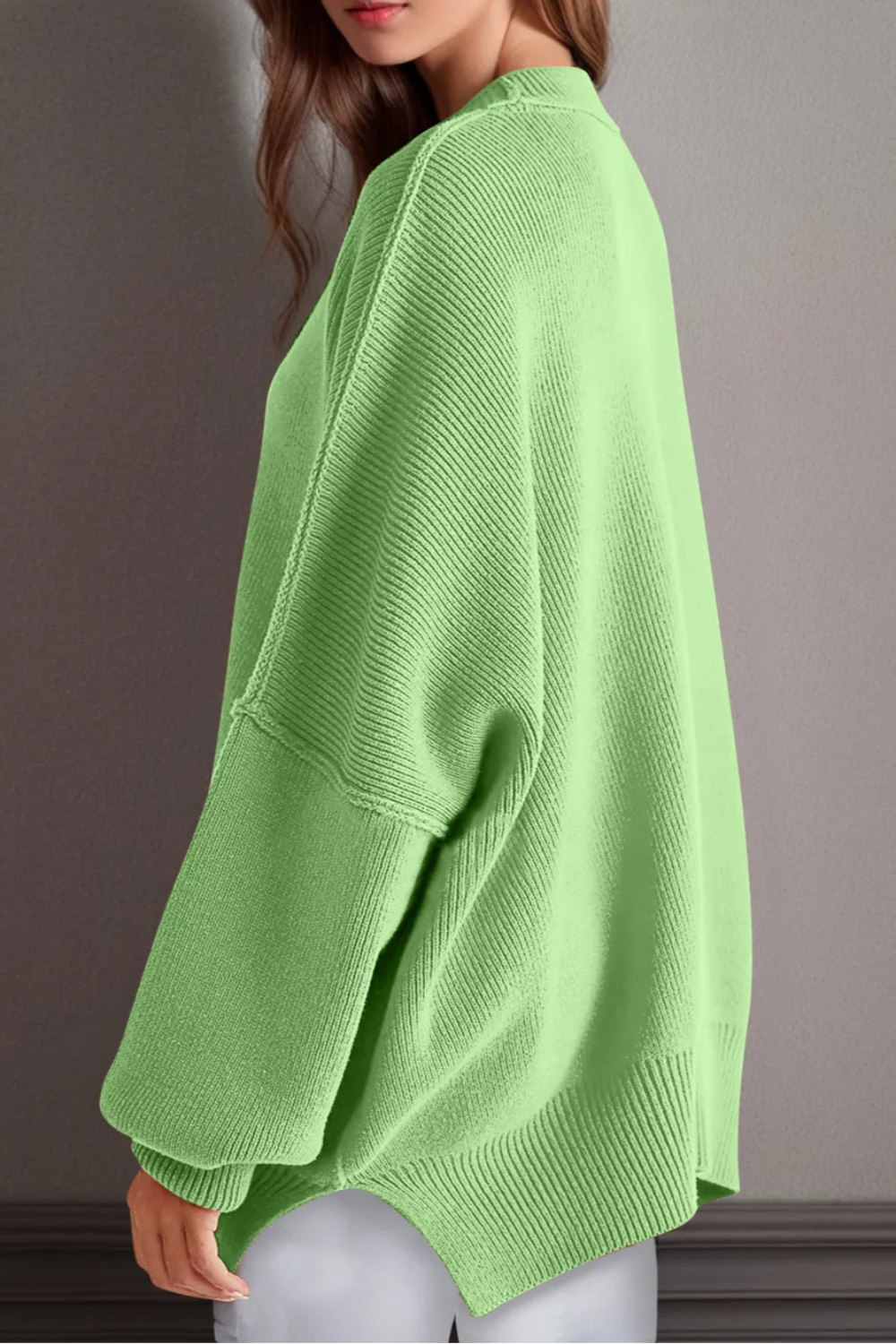 Sweater, oversized, drop shoulder, round neck, exposed seam, long, side slit, ribbed, stretchy side view

