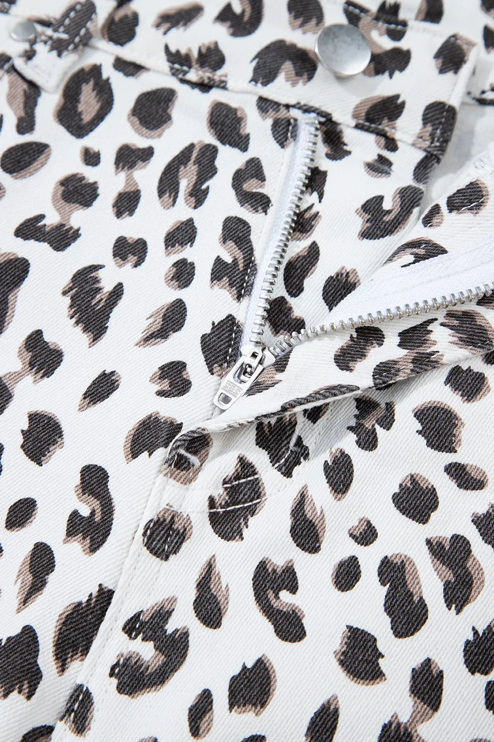Denim shorts, Leopard print, White, Frayed hem, High waist, Functioning pockets, Belt loops, Zipper and button closure, Medium-high elasticity Close up view