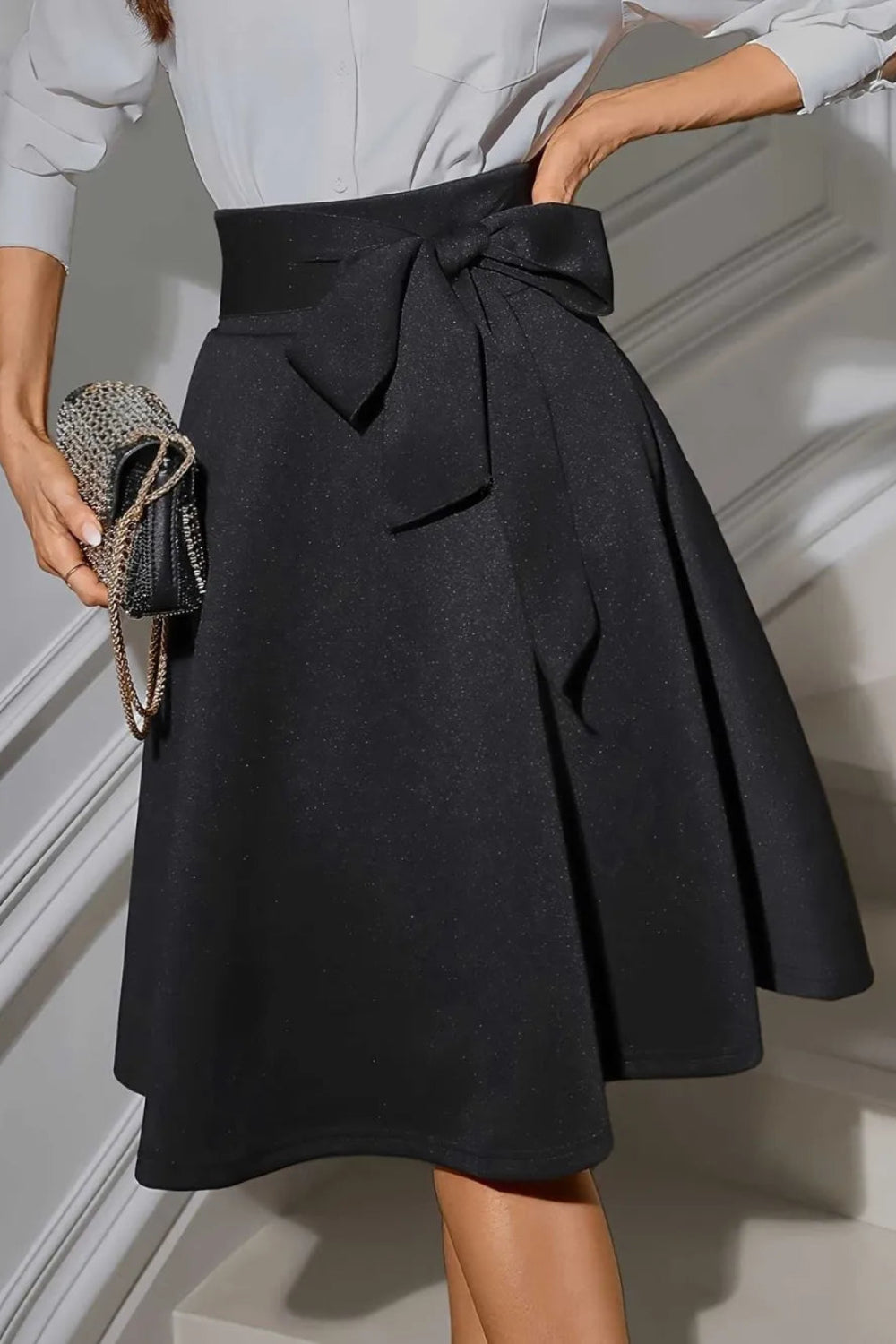 Skirt, knee length, opaque, unlined, tied at the waist, pleated, some stretch, front view
