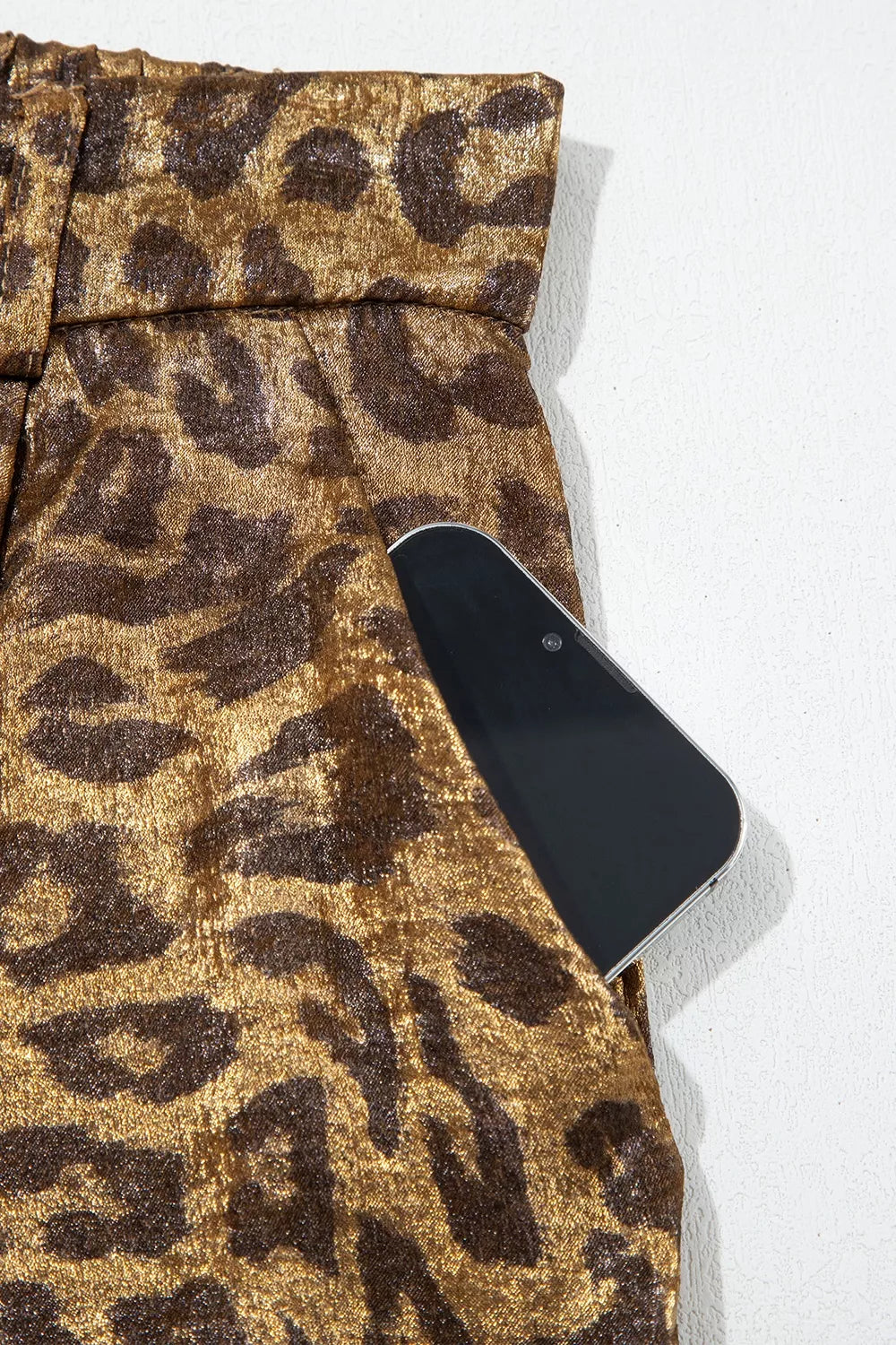 * Pants
* Shiny leopard print
* High-waist
* Back elastic waist
* Wide leg
* Button/zipper closure
* Belt loops
* Buttoned
* No stretch