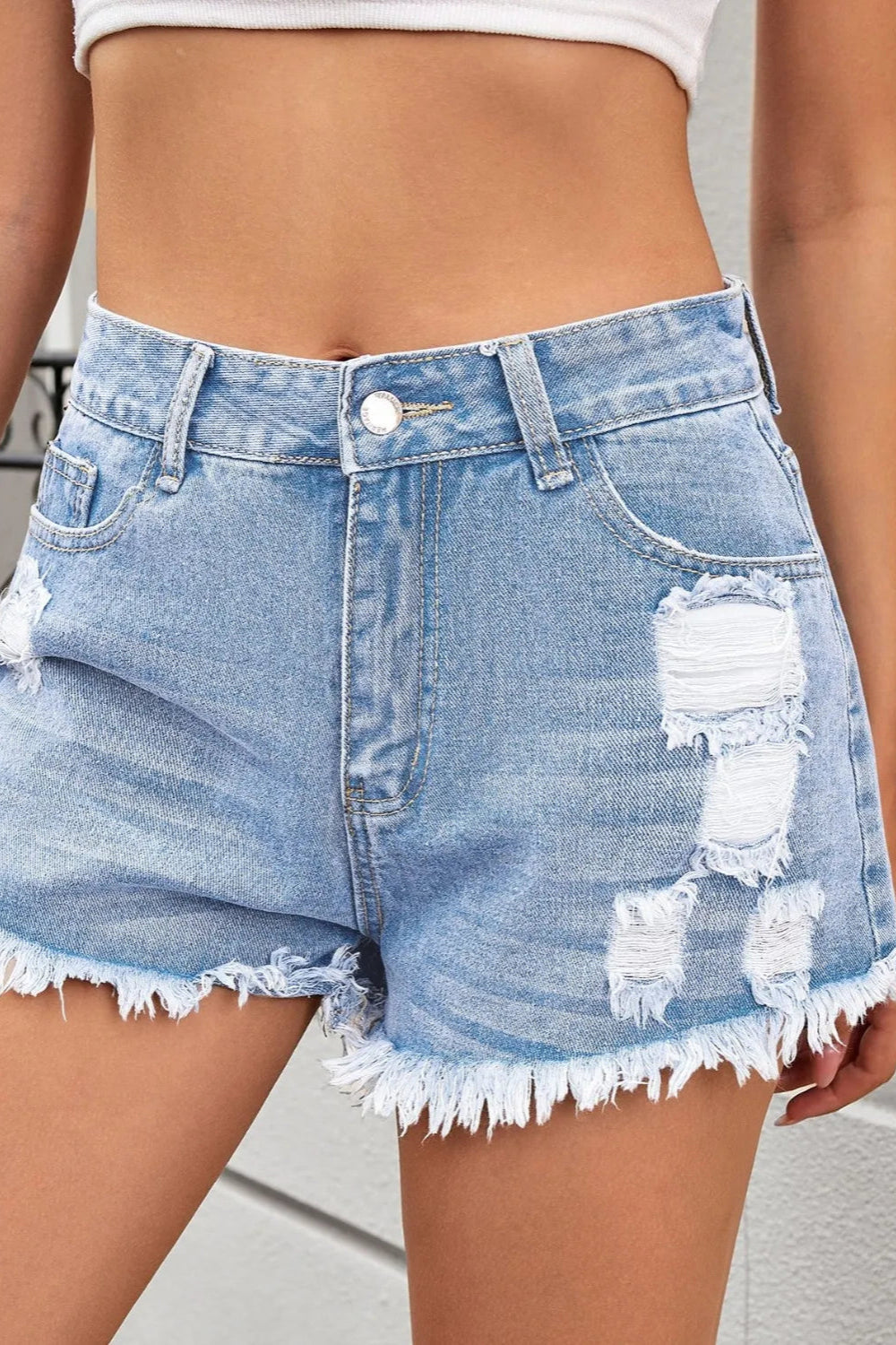 Distressed, Raw hem, High waist, Zipper and button closure, Functioning pockets,  No stretch, Denim shorts Front view