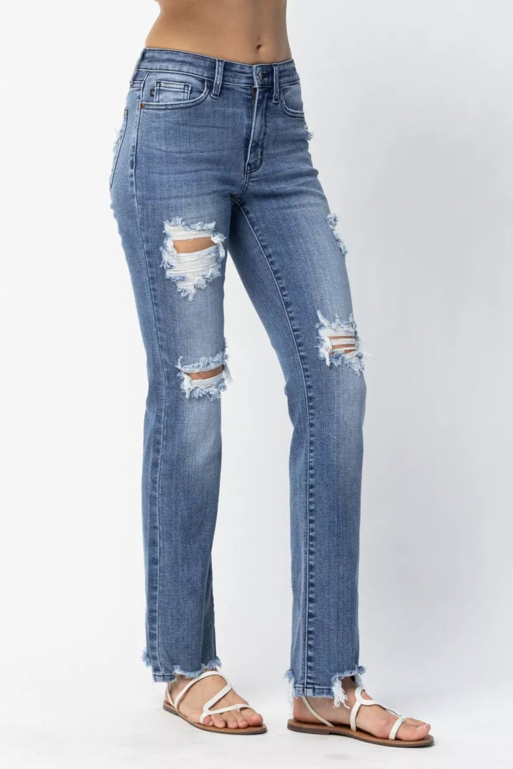 Judy Blue Jeans, full-size, mid-rise, distressed, raw hem, pocketed, belt loops, button/zipper closure, straight leg, medium wash, slightly stretchy, side view