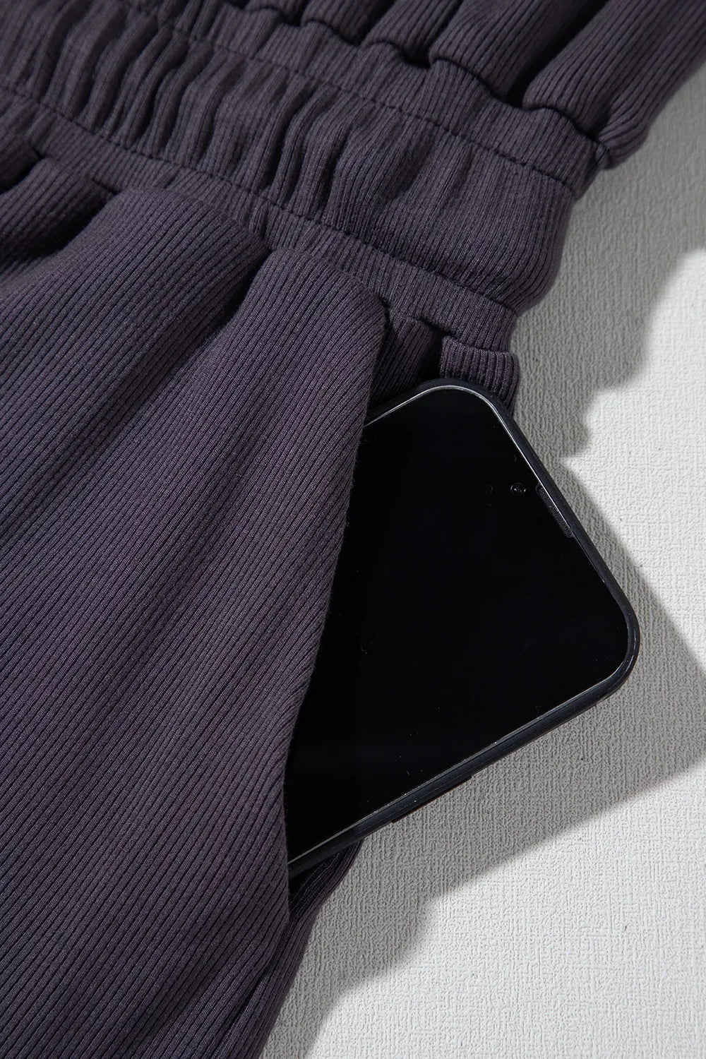 romper, round neck, cap sleeve, knit , drawstring waist, elastic waist, drawstring, button top open back, pleated, stretchy close up view