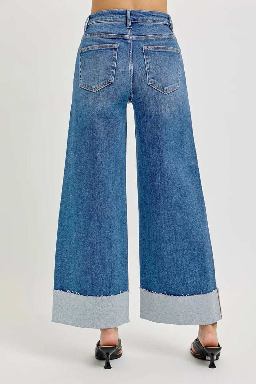 Risen blue jeans, full-size high-rise, tummy control, cropped, wide leg, cuffed, 5-pocket detail, button-zipper closure, belt looped, raw hem, medium wash, slightly stretchy, back view