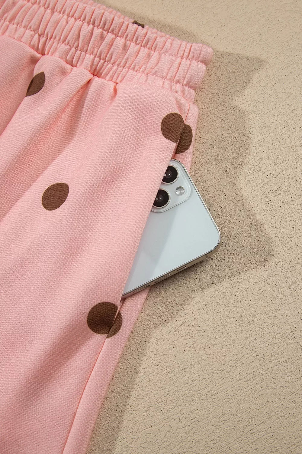 Sweet Pea Short Set in pink with brown polka dots, featuring a long-sleeve top, white mock neck and cuffs, and matching shorts.