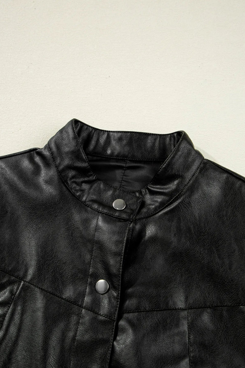 Faux leather jacket, buttoned, pocketed, lined, boxy, no stretch close up view