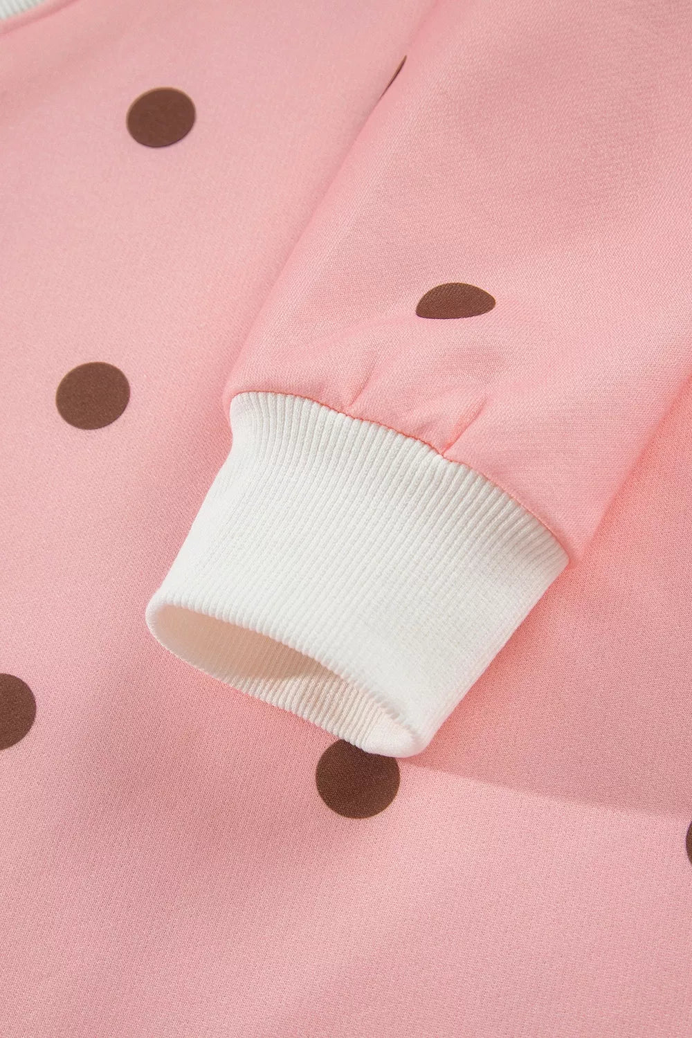 Sweet Pea Short Set in pink with brown polka dots, featuring a long-sleeve top, white mock neck and cuffs, and matching shorts.