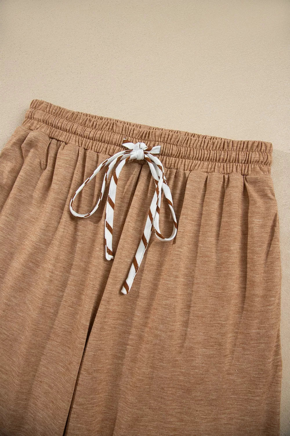 * Two-piece pant set
* Striped
* V-neck
* Long sleeve
* Drop shoulder
* Ruffled cuffs
* Side slit
* Elastic waist
* Drawstring
* Pocketed
* Ruffled
* Contrast trim
* Moderate stretch