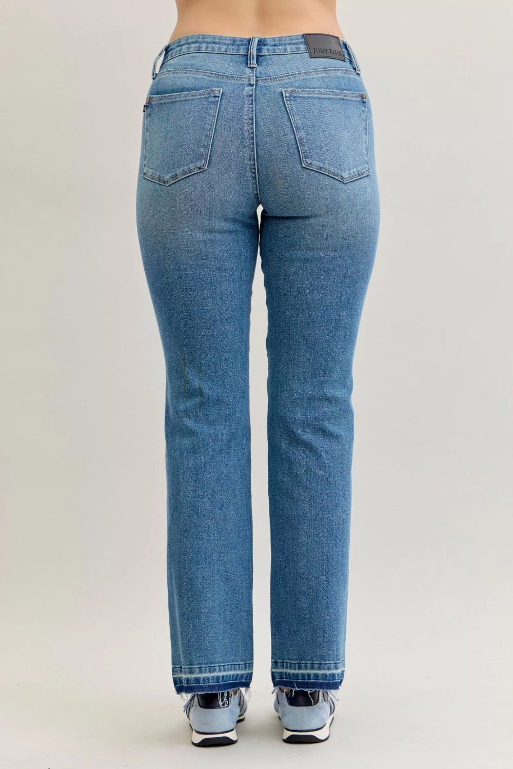 Judy Blue Jeans, full-size, mid-rise, medium wash, slim, bootcut, tummy control, release hem, pocketed, belt loops, button/zipper closure, raw hem, slightly stretchy, back view
