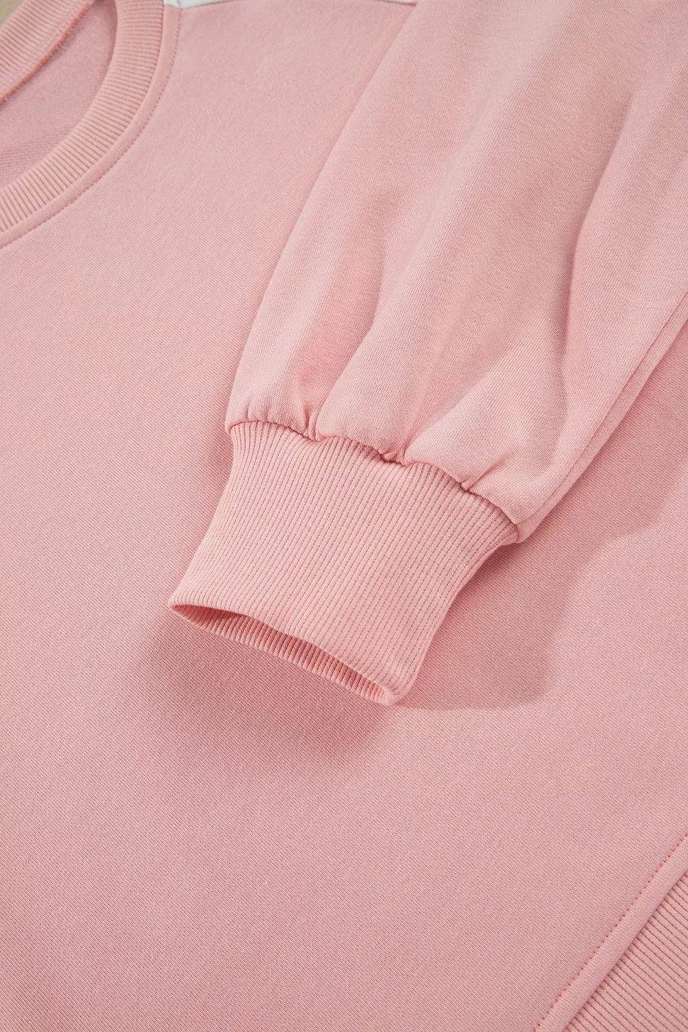 Social Club Pant Set with a light pink cropped sweatshirt, polka-dot shoulder panels, and matching wide-leg drawstring pants close up view.