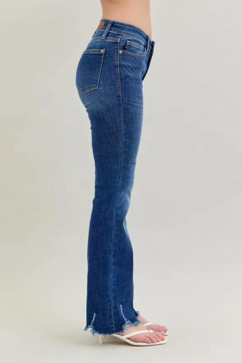 Judy Blue Jeans, full-size, mid-rise, vintage dark wash, 5-pocket design, relaxed fit, button-zip closure, distressed hem, subtle whiskering, bootcut, slightly stretchy, side view