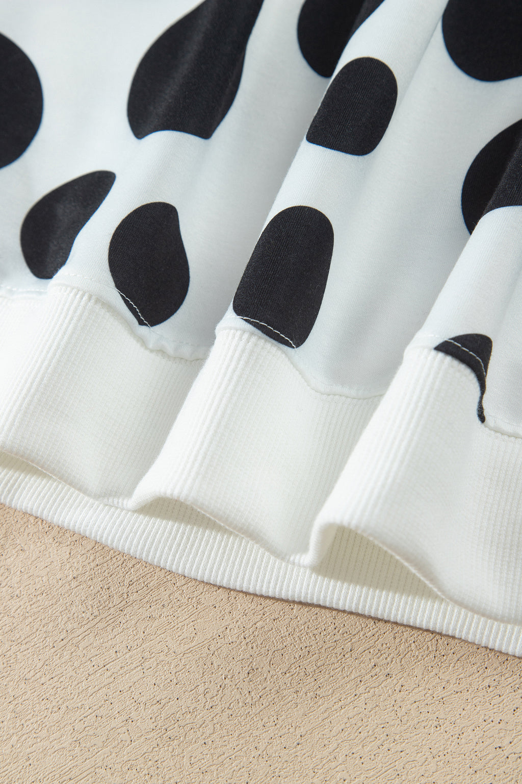 Point Taken Pant Set In Black with an ivory-and-black polka-dot sweatshirt and matching wide-leg drawstring pants close up view.