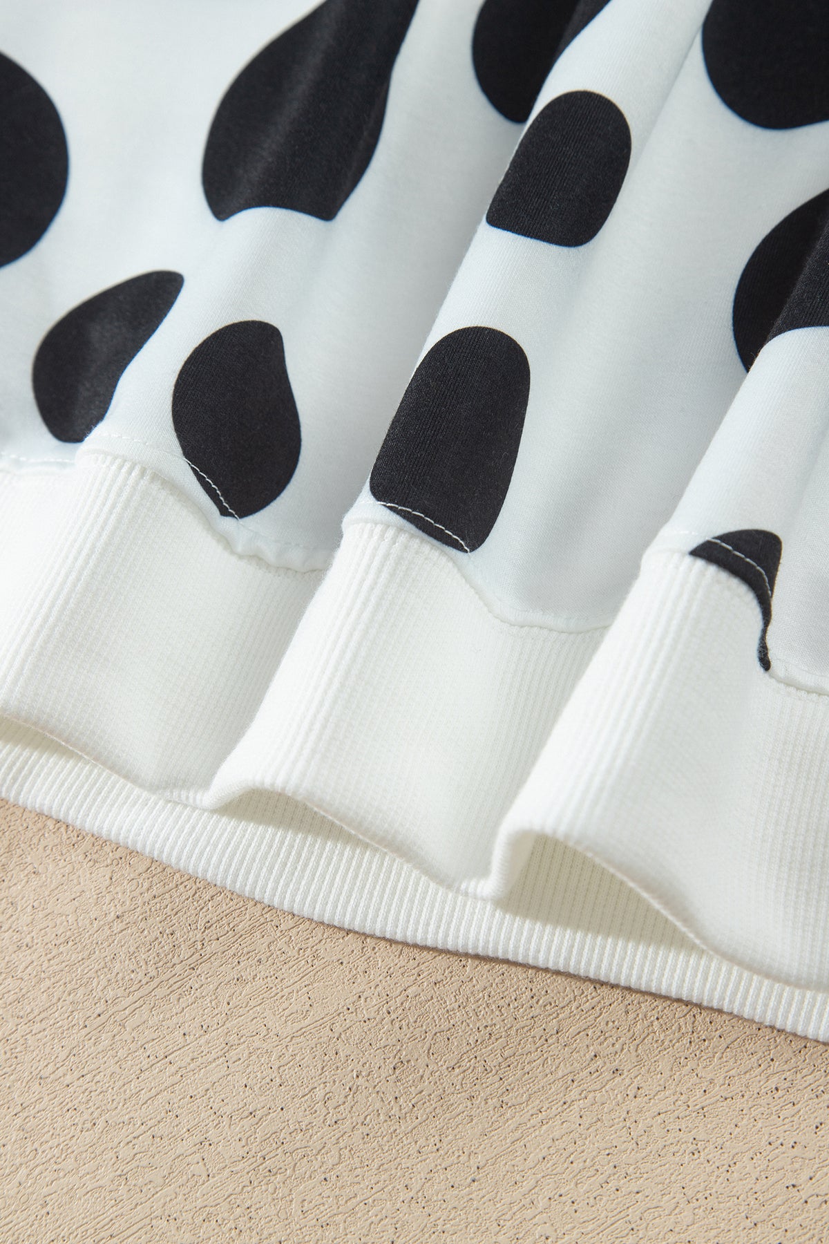 Point Taken Pant Set In Black with an ivory-and-black polka-dot sweatshirt and matching wide-leg drawstring pants close up view.