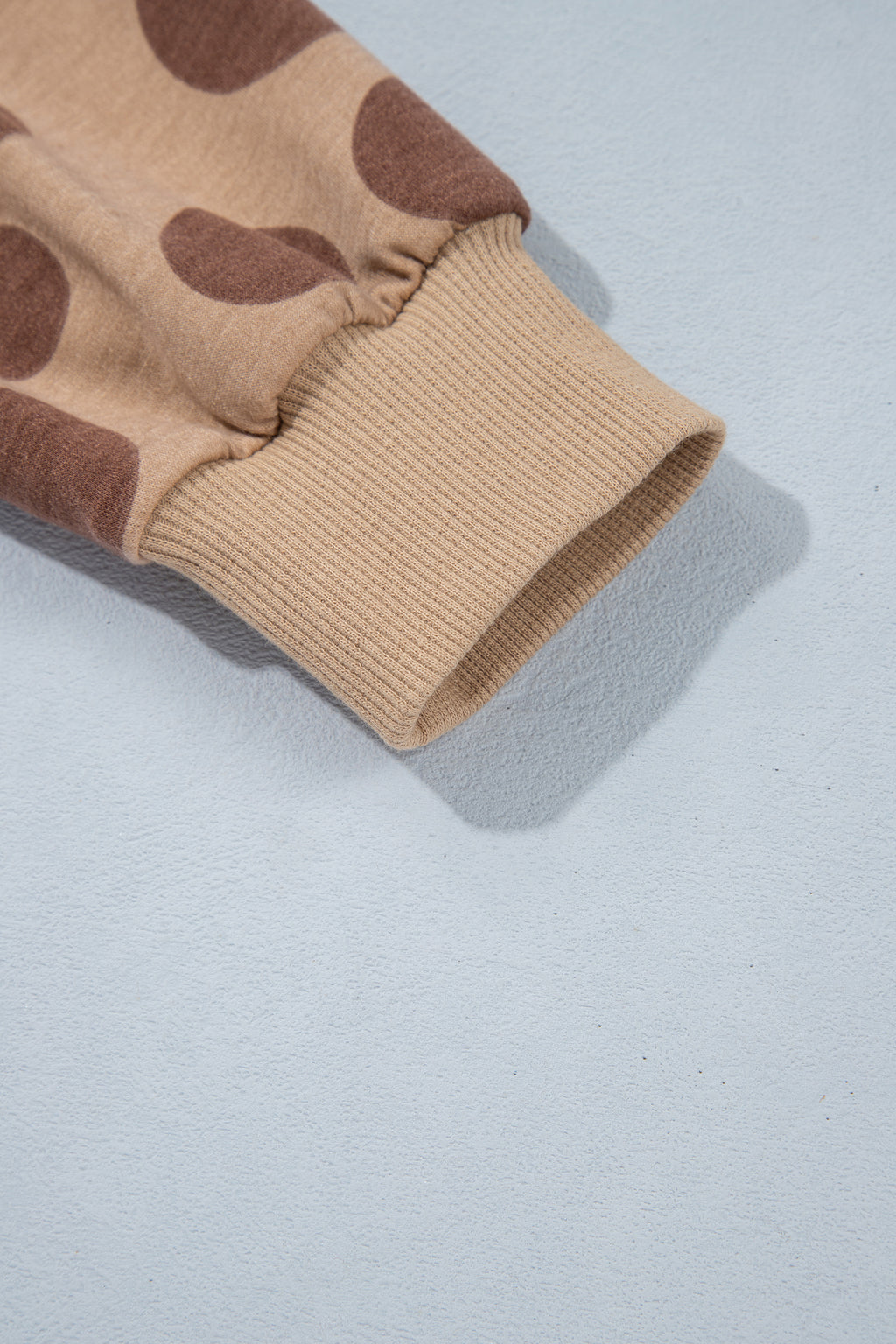 Point Taken Pant Set In Brown with an brown-and-tan polka-dot sweatshirt and matching wide-leg drawstring pants close up view.