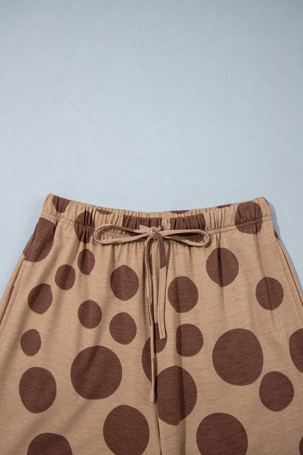 Point Taken Pant Set In Brown with an brown-and-tan polka-dot sweatshirt and matching wide-leg drawstring pants close up view.