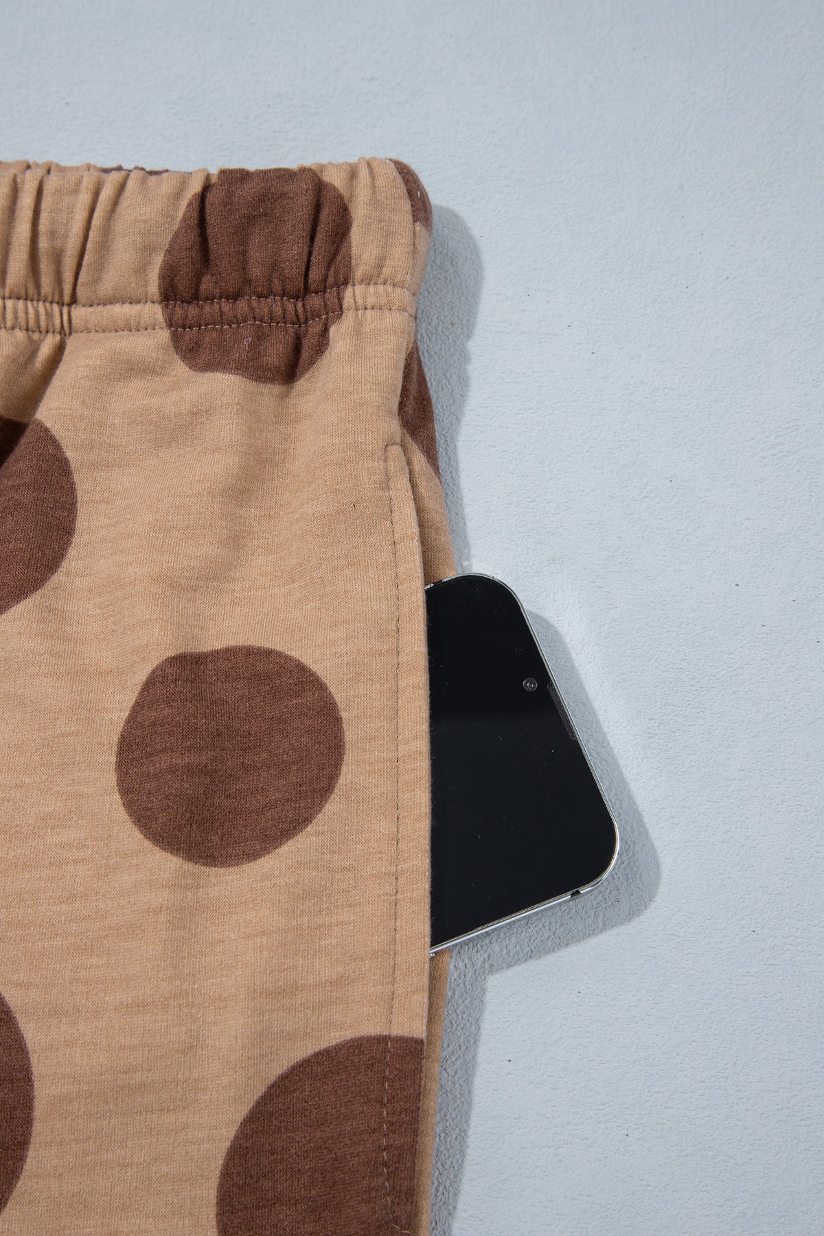 Point Taken Pant Set In Brown with an brown-and-tan polka-dot sweatshirt and matching wide-leg drawstring pants close up view.