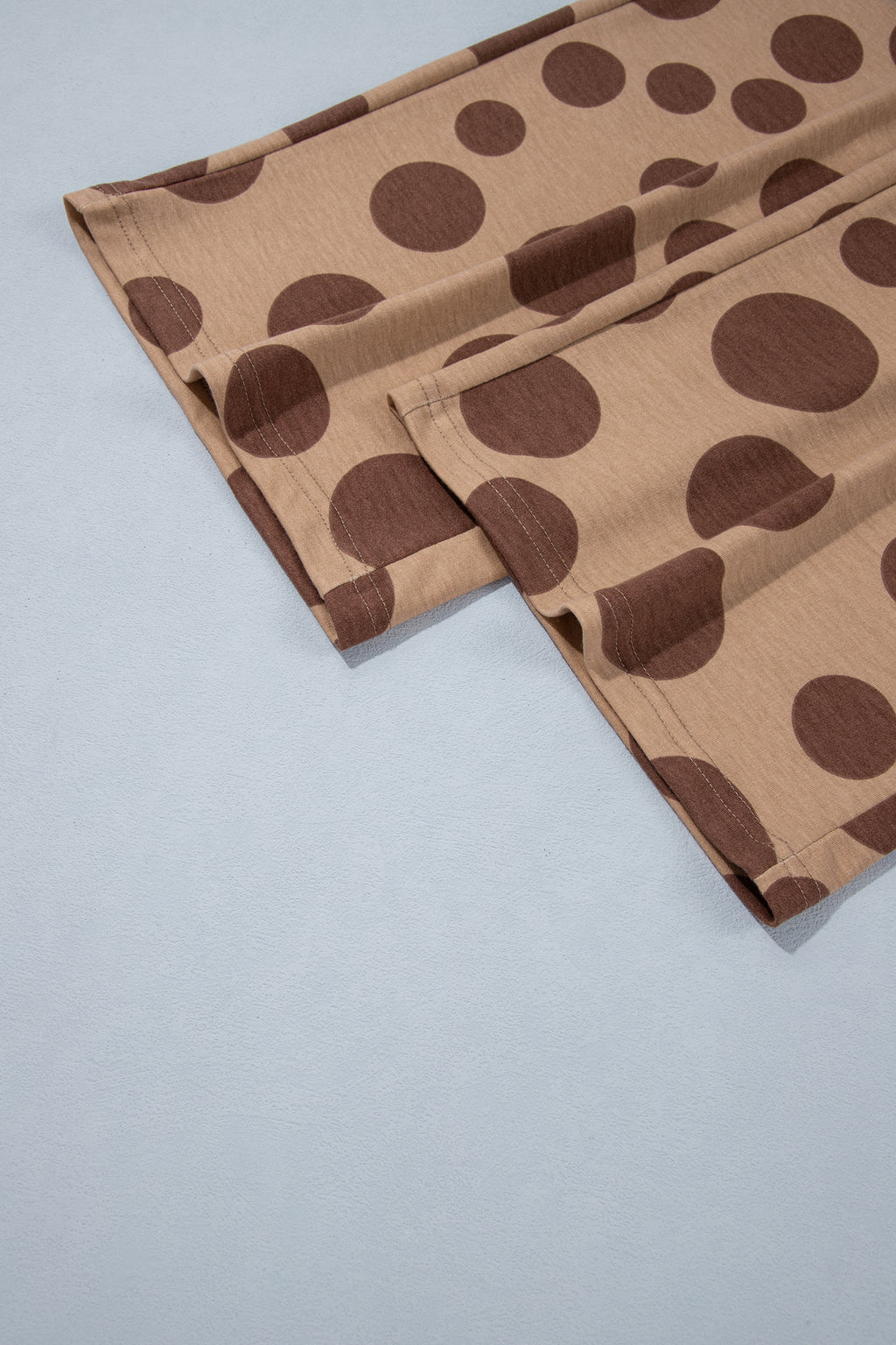 Point Taken Pant Set In Brown with an brown-and-tan polka-dot sweatshirt and matching wide-leg drawstring pants close up view.