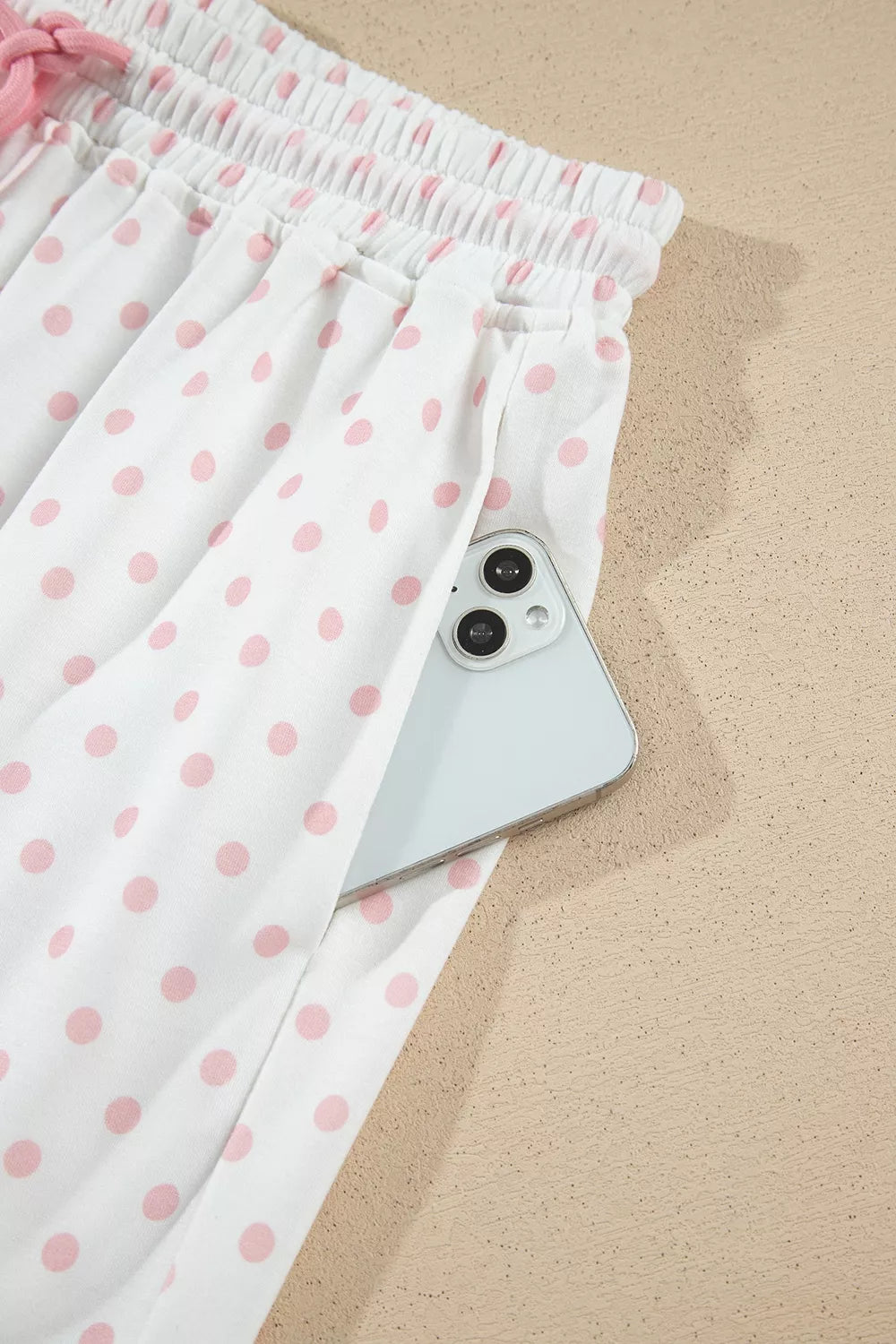 Social Club Pant Set with a light pink cropped sweatshirt, polka-dot shoulder panels, and matching wide-leg drawstring pants close up view.