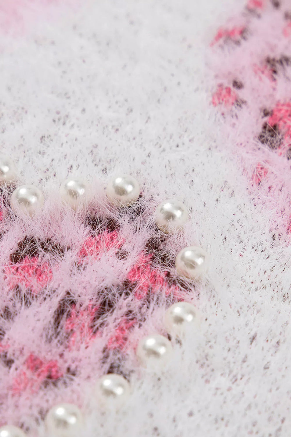 sweater, pullover, round neck, drop shoulder, ribbed neck, cuffs and hem, long sleeve, fuzzy texture, hearts with leopard print adorned with pearl trim, slightly stretchy, close up