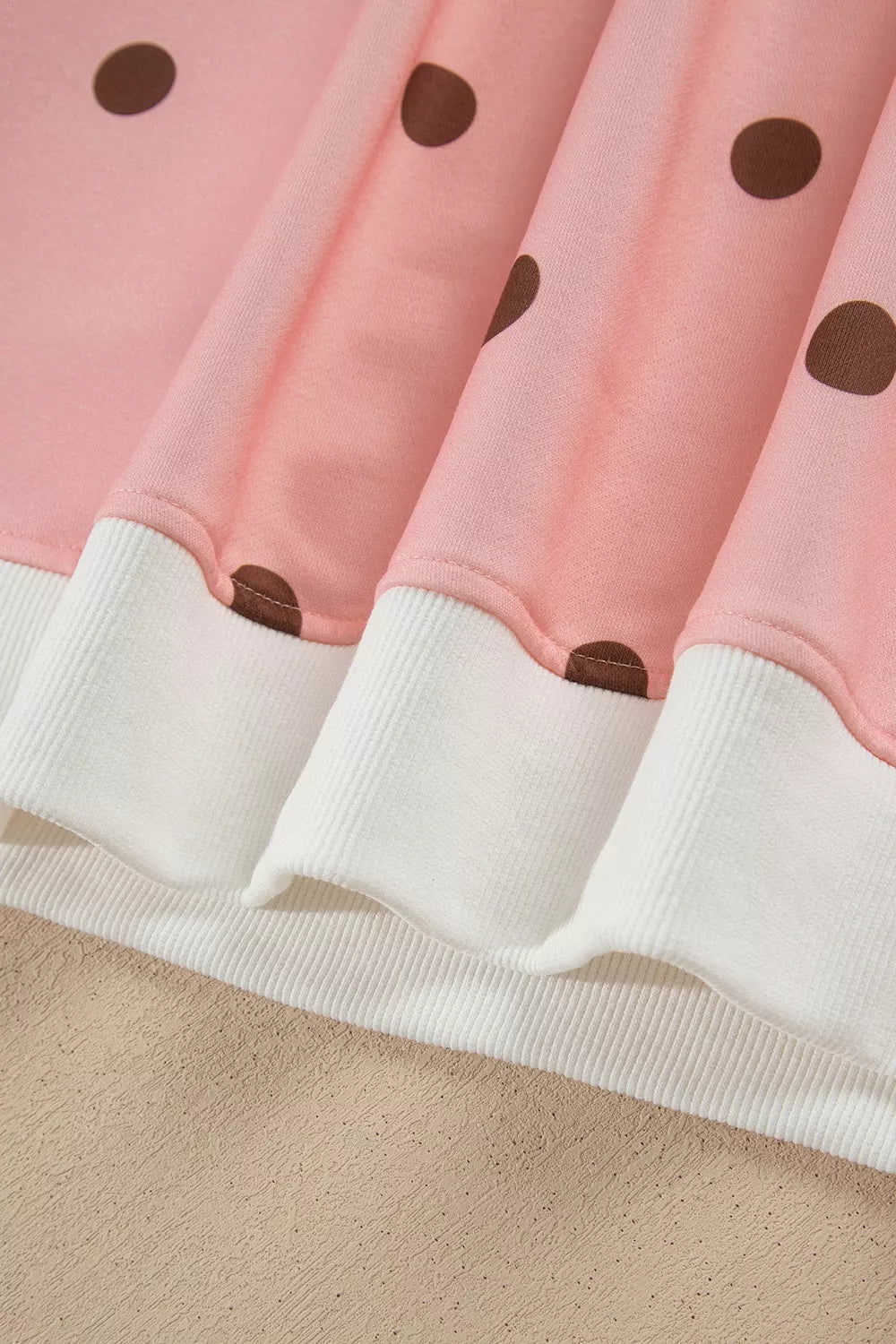 Sweet Pea Short Set in pink with brown polka dots, featuring a long-sleeve top, white mock neck and cuffs, and matching shorts.