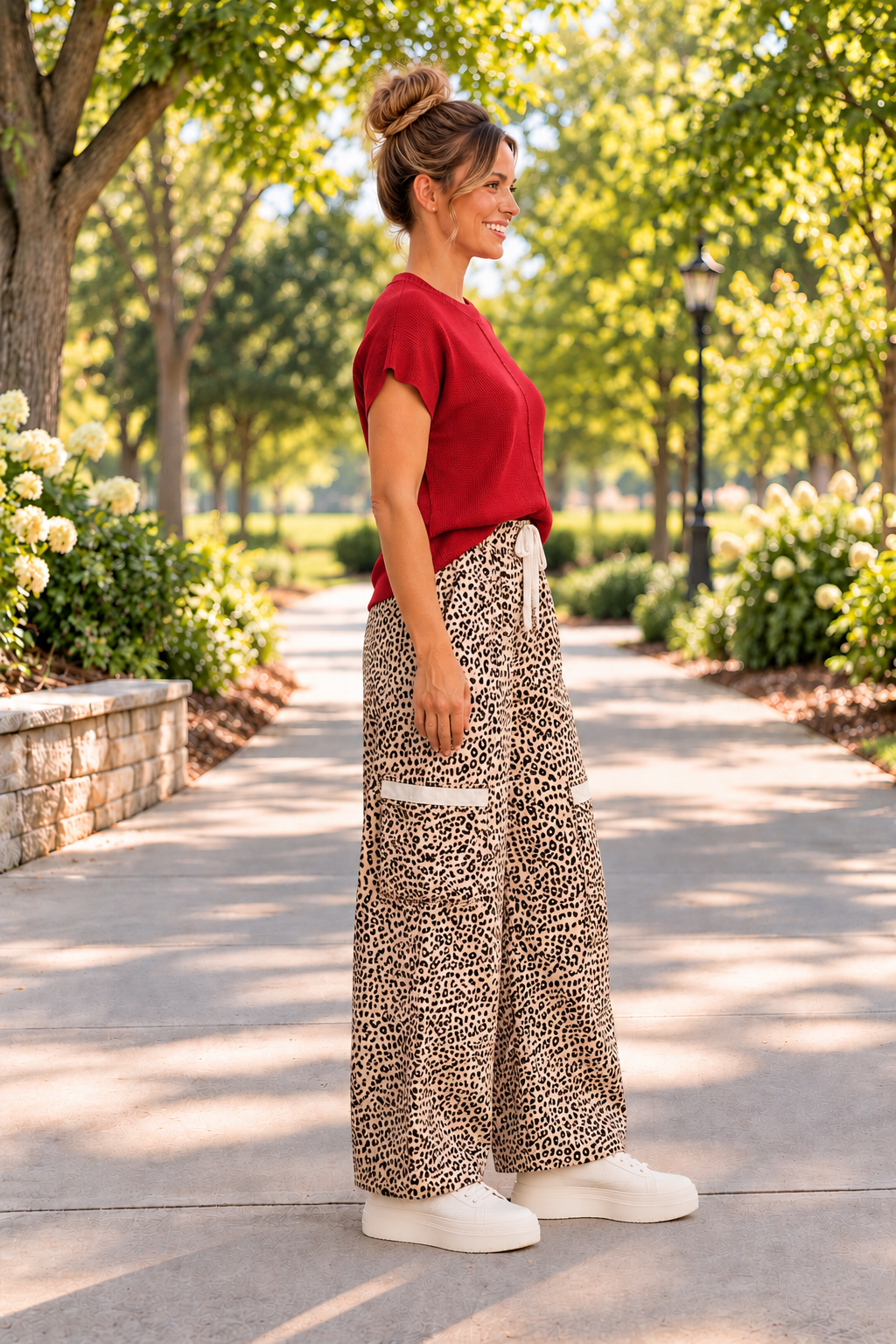The Ziggy Pants in a beige and black leopard print with wide legs, a drawstring waist, and front patch pockets. Side view.