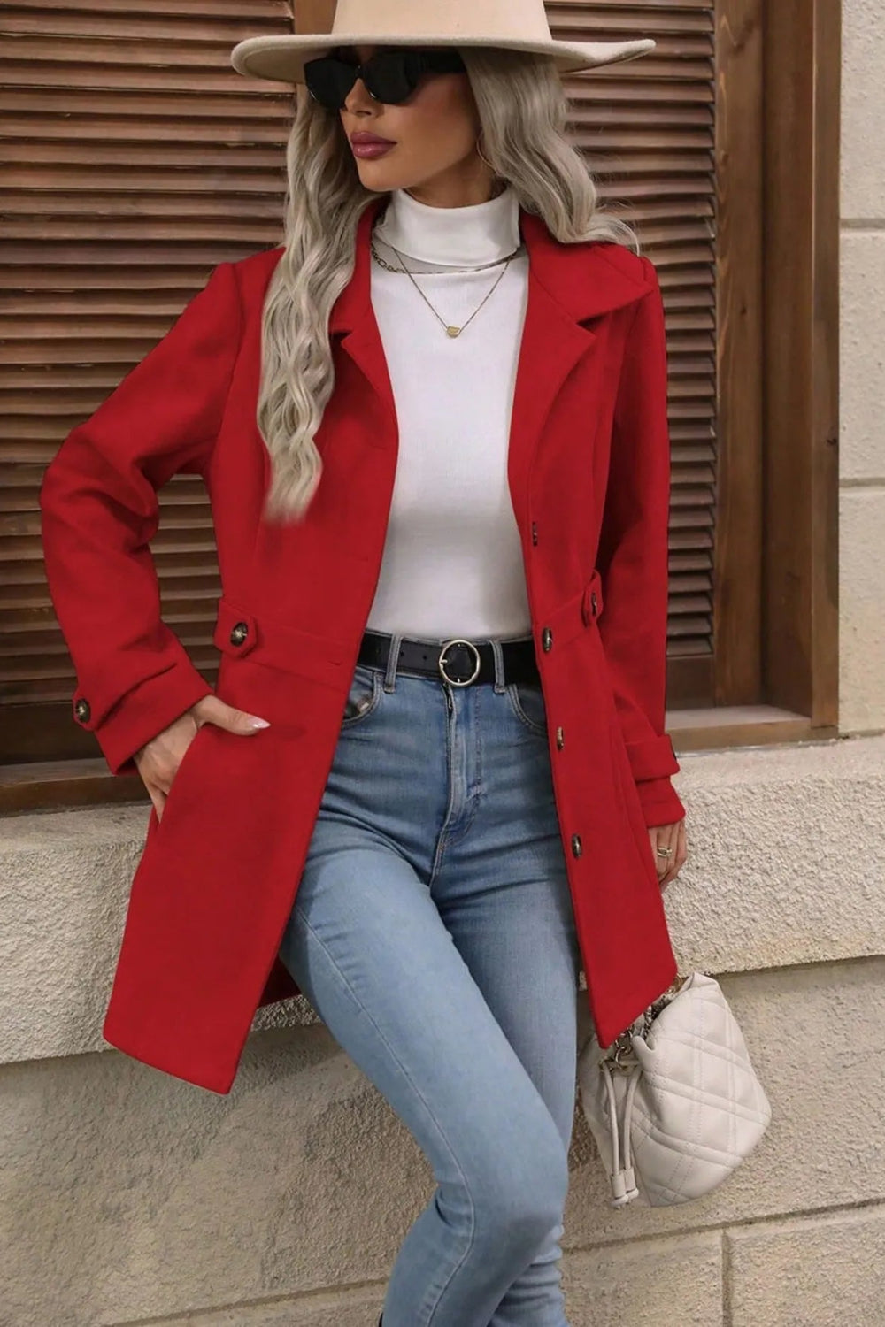 Coat, collared, buttoned, pockets, unlined, cuff straps, martingale belt, narrows at the waist, no stretch, front view