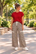 The Ziggy Pants in a beige and black leopard print with wide legs, a drawstring waist, and front patch pockets.