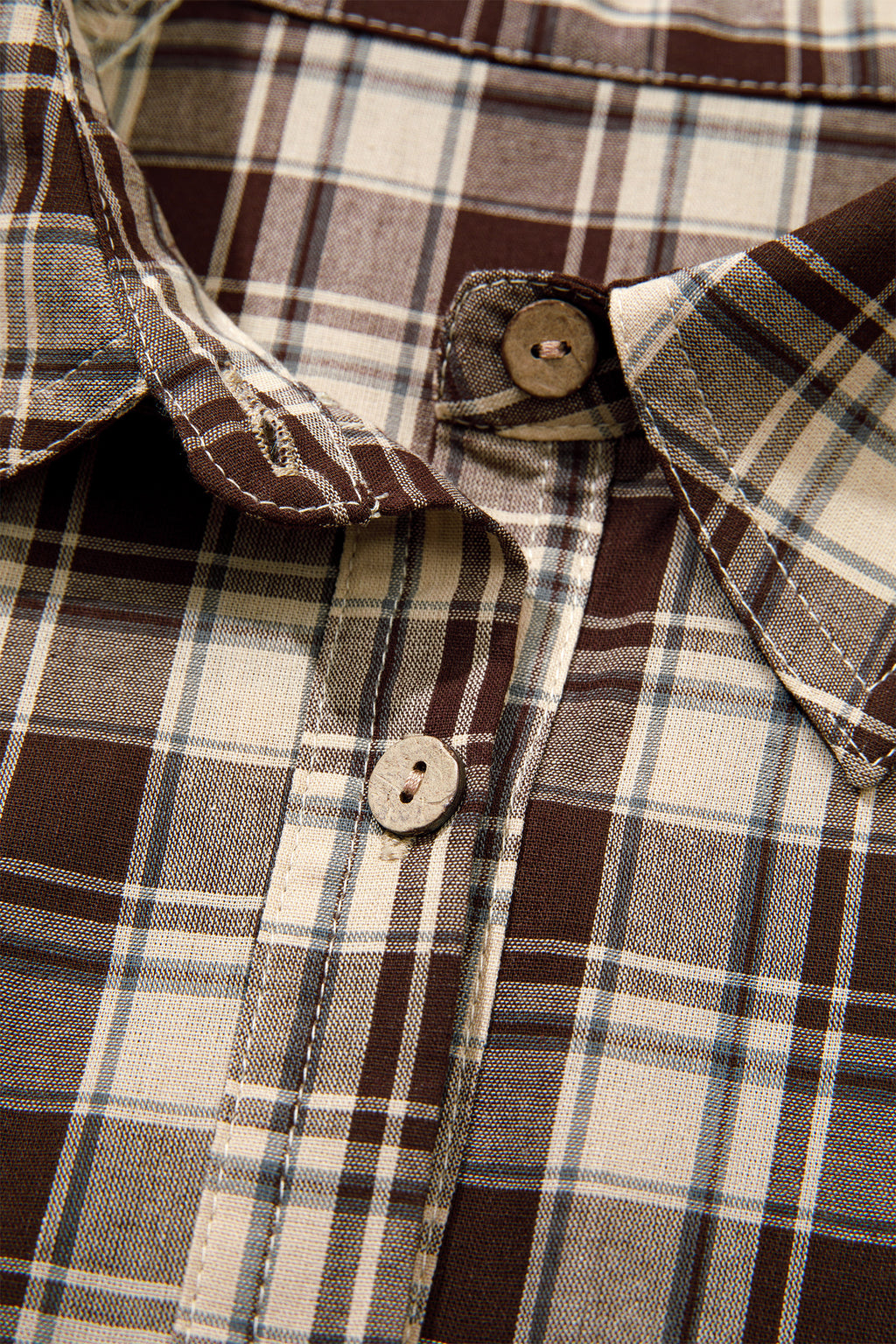 Front view of the Well Thought Of Mini Dress in brown and cream plaid with a collared button front, long sleeves, and pockets.