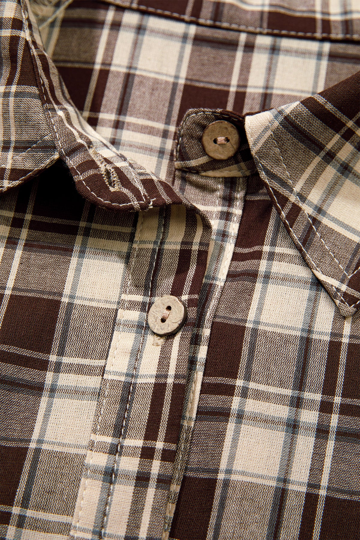 Front view of the Well Thought Of Mini Dress in brown and cream plaid with a collared button front, long sleeves, and pockets.